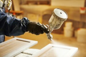 Painting kitchen cabinets white with a paint spray gun